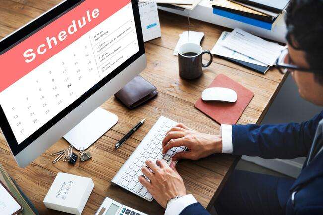 Businessman holding a tablet with a calendar displaying the word 'APPOINTMENT