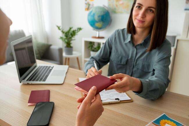 A woman handing over a passport during a consultation, emphasizing immigration case management services.